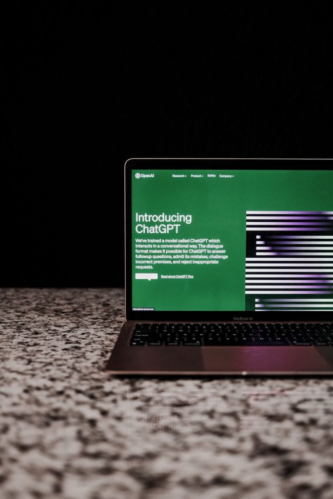 How to Add a Free AI Chatbot WordPress Plugin with AI Marketing Expert – Turn Visitors into Leads 3 Laptop showing ChatGPT interface on a marble surface, showcasing AI technology.