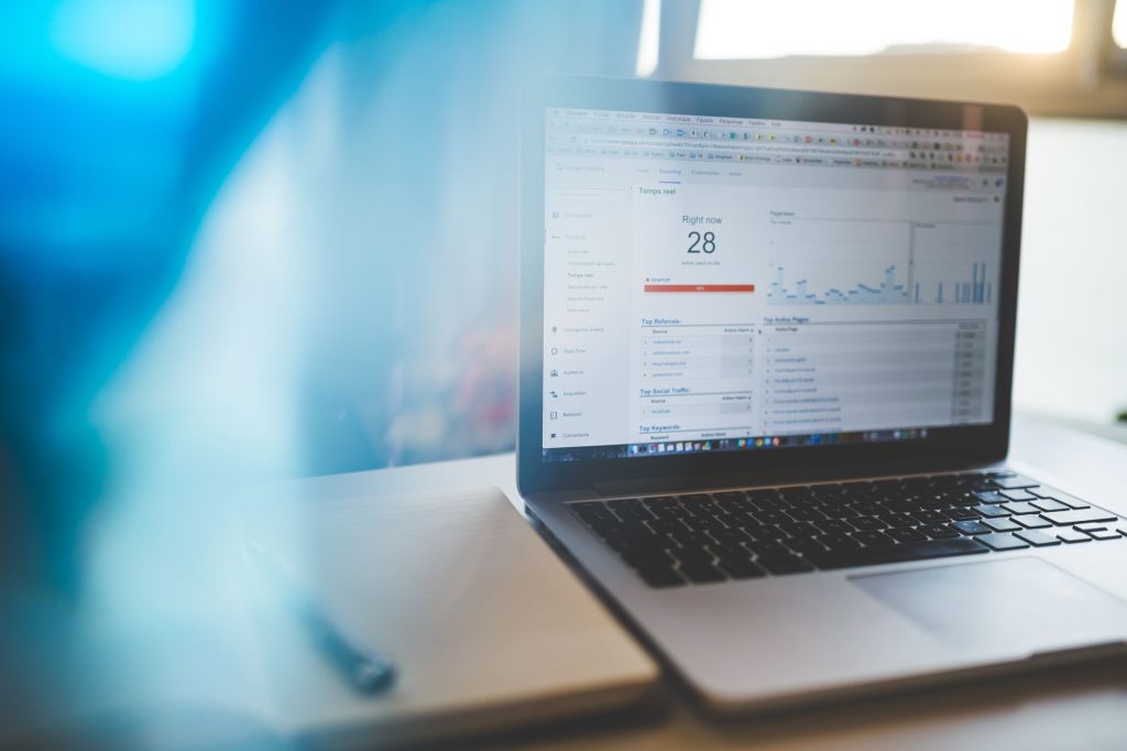 How to Optimize Your WordPress Site for Local 'Near Me' Searches Using AI 1 Laptop displaying Google Analytics in a modern workspace, highlighting digital analytics and technology.