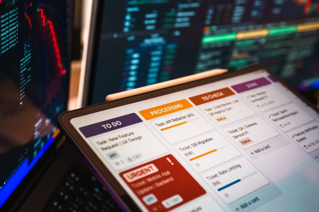 { 1 Kanban board displayed on screen with charts and data analysis in modern office setup.