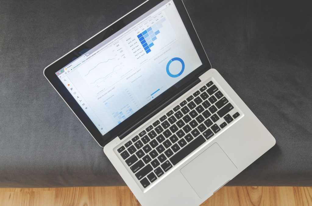 How to Download the Free AI Marketing Expert Plugin to Master Your Content Strategy 1 Overhead view of a laptop showing data visualizations and charts on its screen.