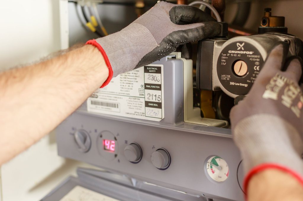 5 Proven Steps to Build Topical Authority WordPress 1 Close-up of hands adjusting a boiler system with precise instrumentation, showing maintenance work. - topical authority WordP
