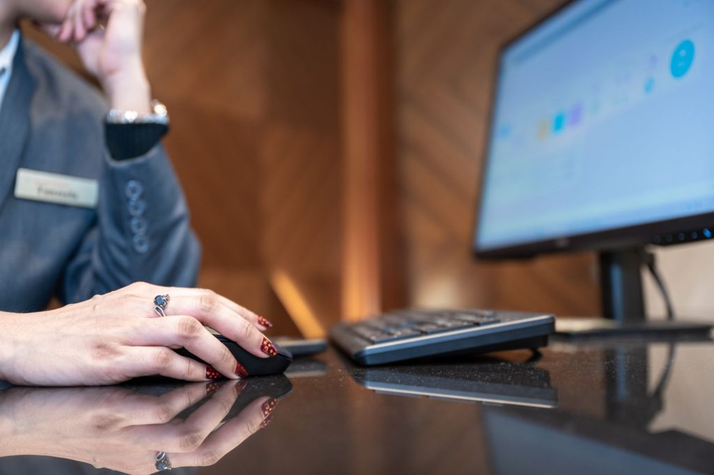 AI Marketing Expert Plugin: Automate Customer Engagement and Boost Local SEO 1 Close-up of a business professional using a computer mouse and keyboard in a modern office environment.