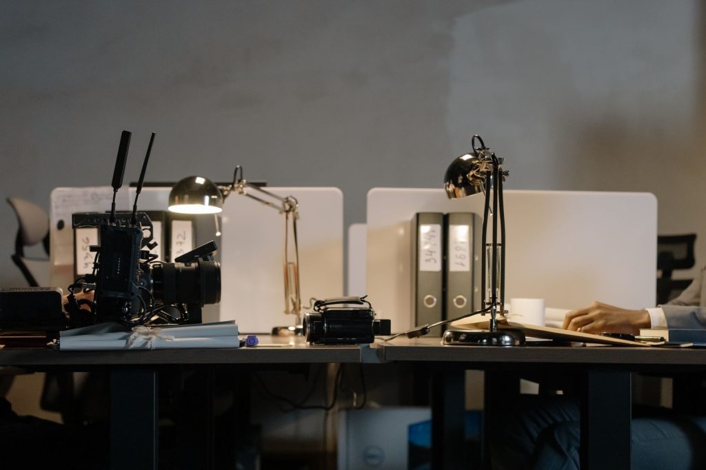 Consolidate Your Tools with the Free AI Marketing Expert Plugin 1 A contemporary office setup featuring desks with lamps, a camera, and divided workspace layout.
